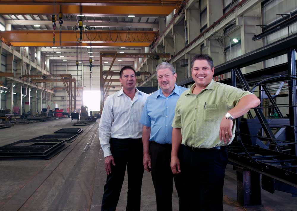 the leaders of weldall manufacturing - dan bahl, dave bahl senior and david bahl junior at their manufacturing facility in wisconsin