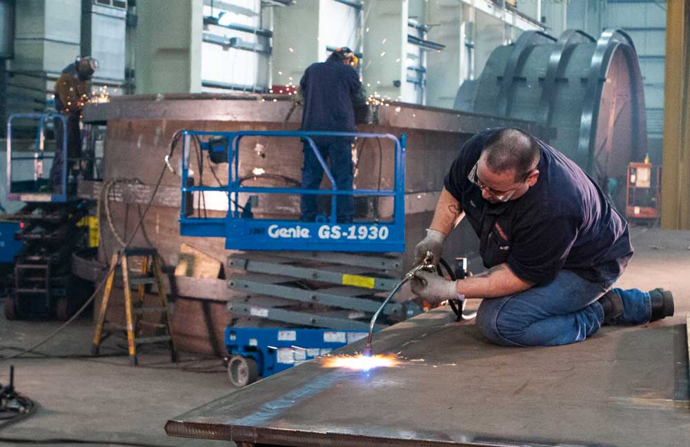 weldall manufacturing employees take pride in their values including quality welding and fabrication as shown by this worker